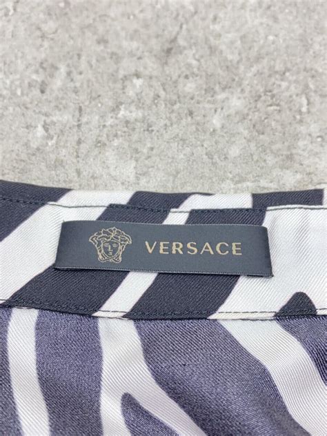 versace giraffe print blanket|Versace silk pillows.